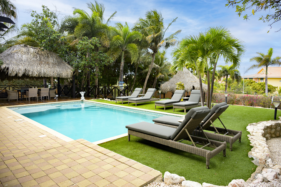 Pool, sun loungers and shaded palapa at Bayside Hill